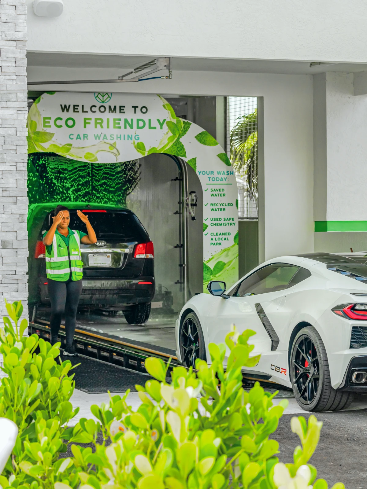 Welcome to Eco Friendly Car Washing entrance with a car inside the wash tunnel