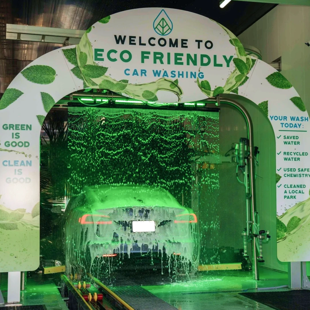 Welcome to Eco Friendly Car Washing entrance with a car inside the wash tunnel