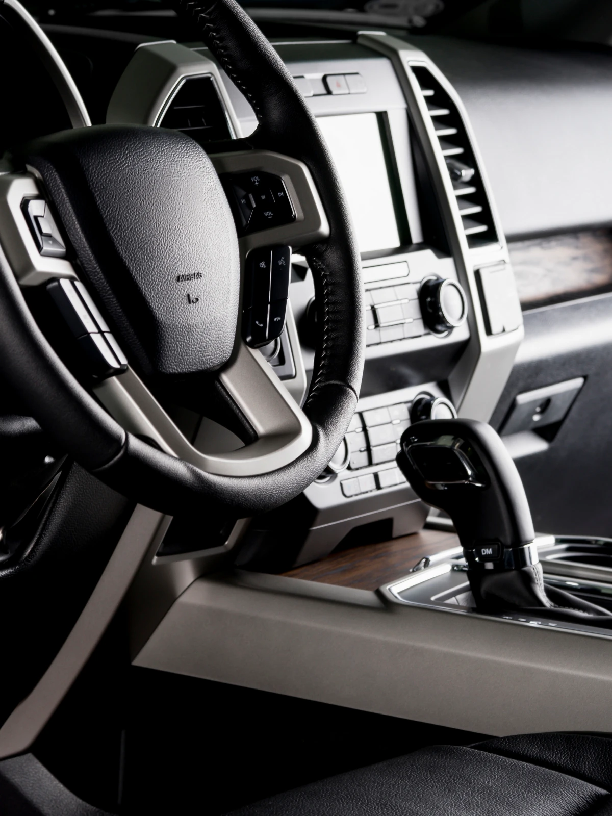 Close-up of a truck's steering wheel and dashboard controls