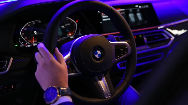 Close-up of a BMW steering wheel and dashboard at night