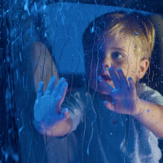 Young boy watching car wash