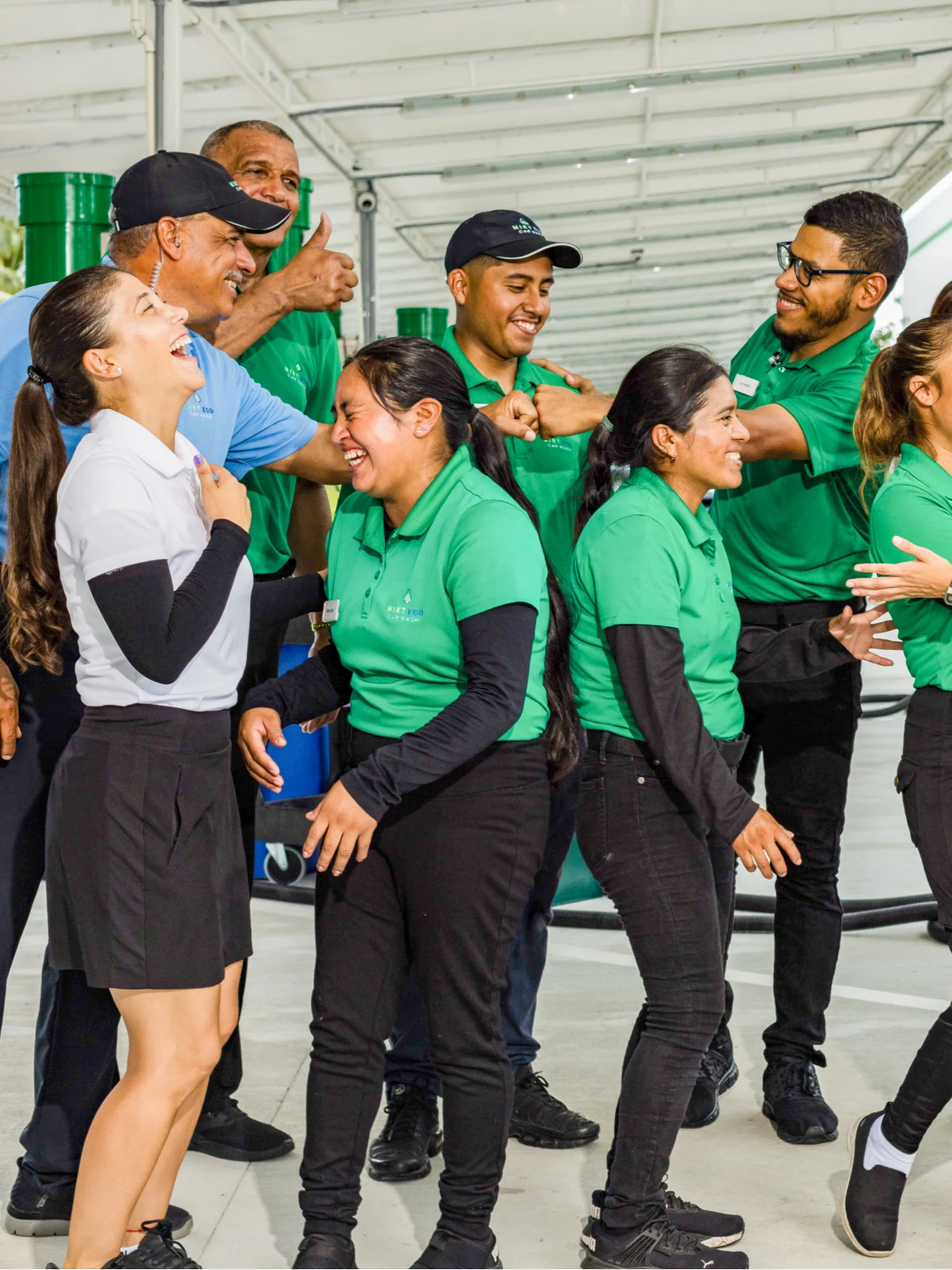 Mint Eco team members high-fiving and celebrating together