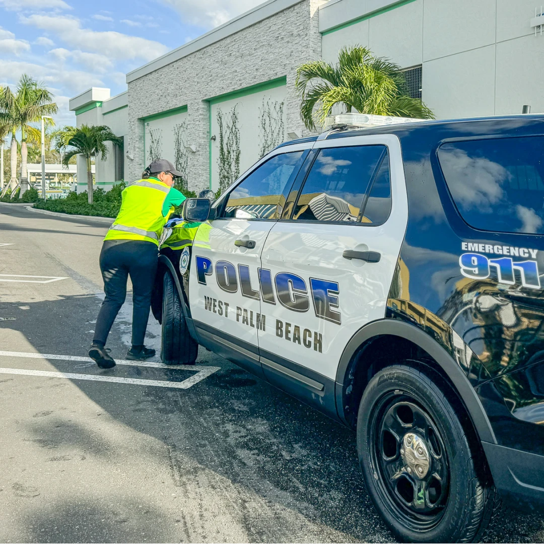 Mint Eco employee washing a West Palm Beach Police vehicle