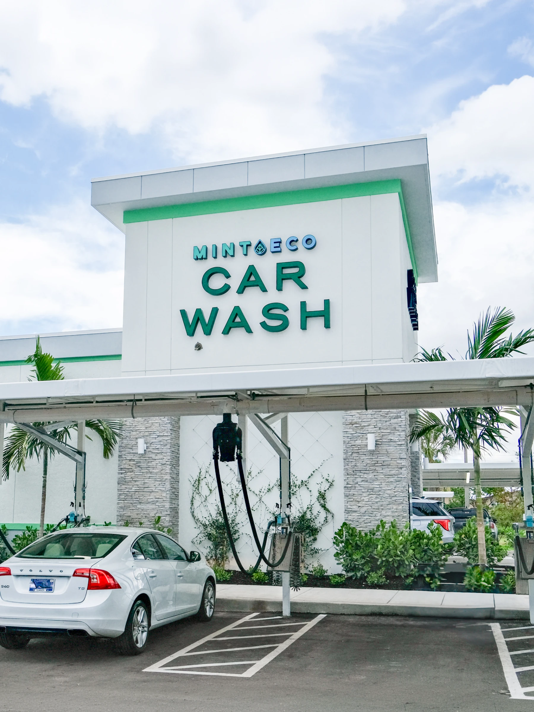 Mint Eco Car Wash building entrance with signage and wash bay at the Okeechobee Blvd and Turnpike East location