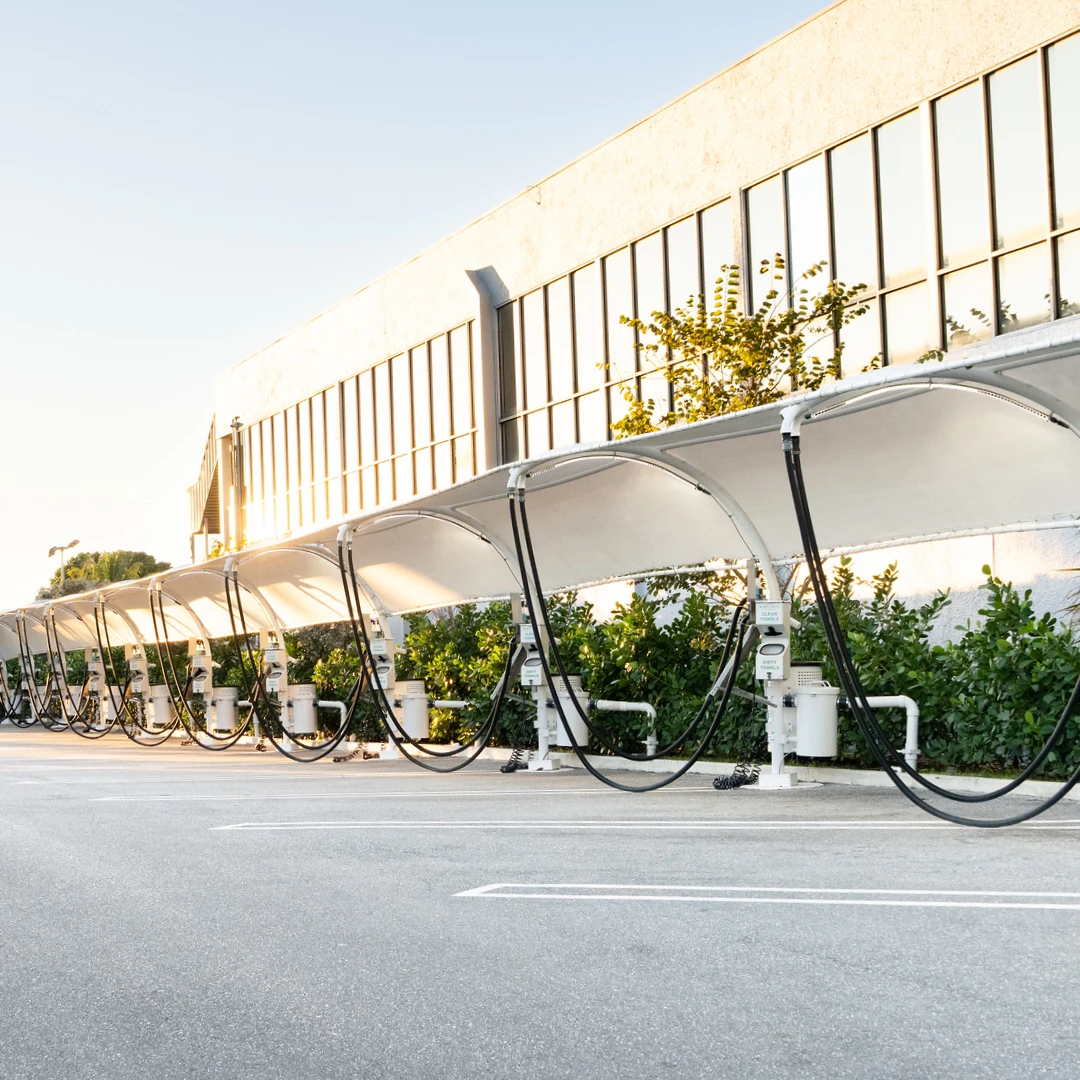 Row of vacuum stations under a canopy at golden hour