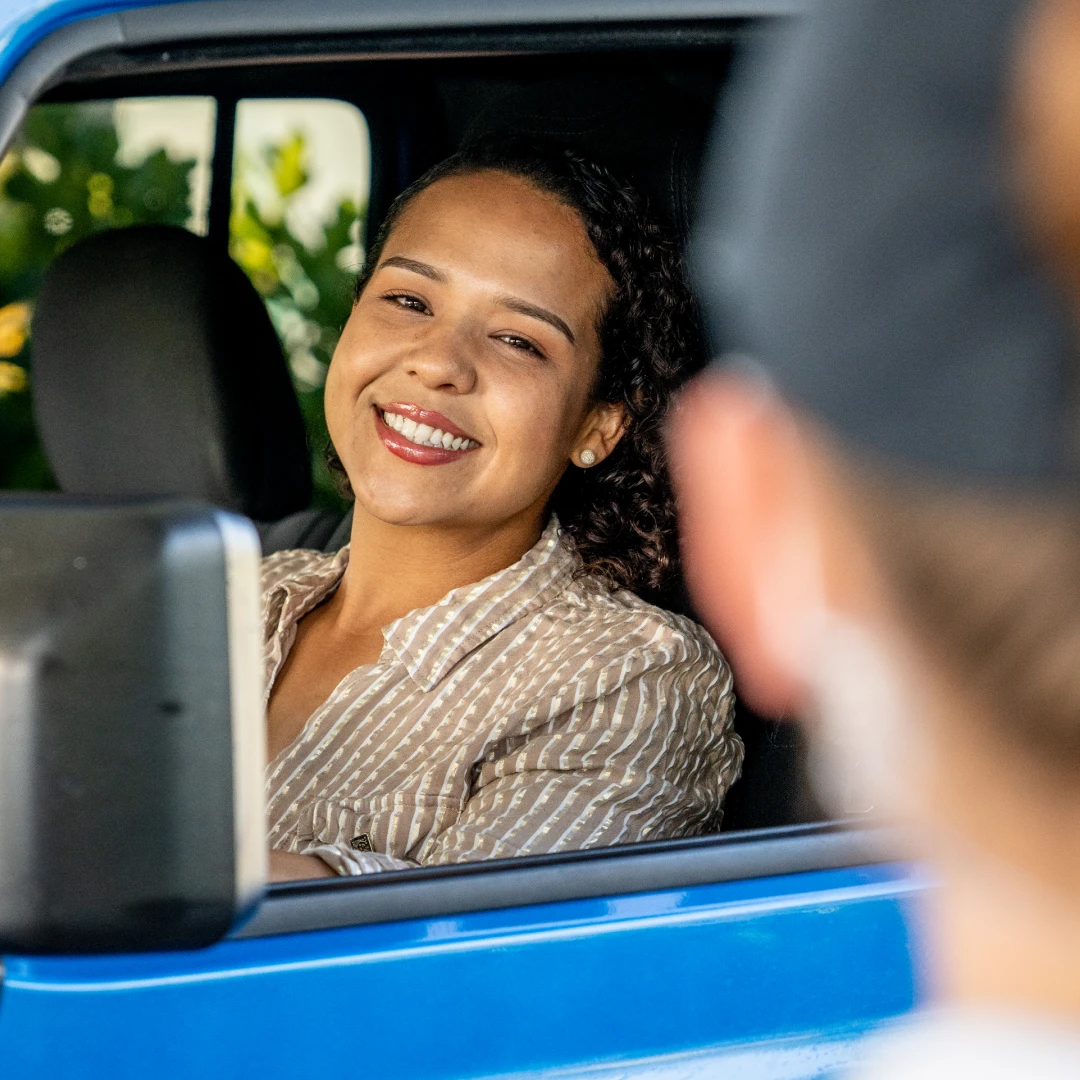 Woman smiling inside a truck at the car wash