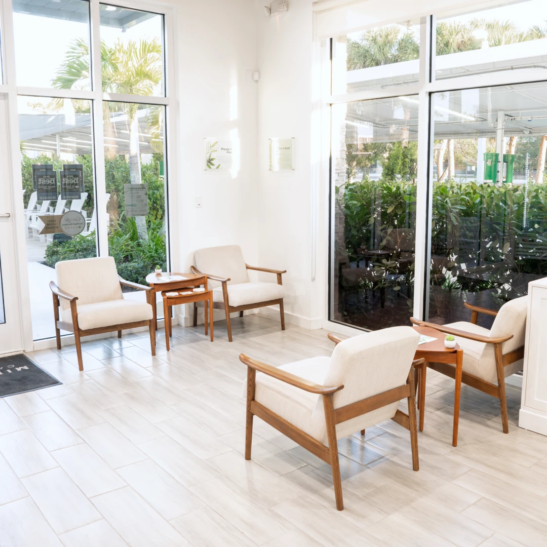 Lobby seating area with lounge chairs at a Mint Eco Car Wash location