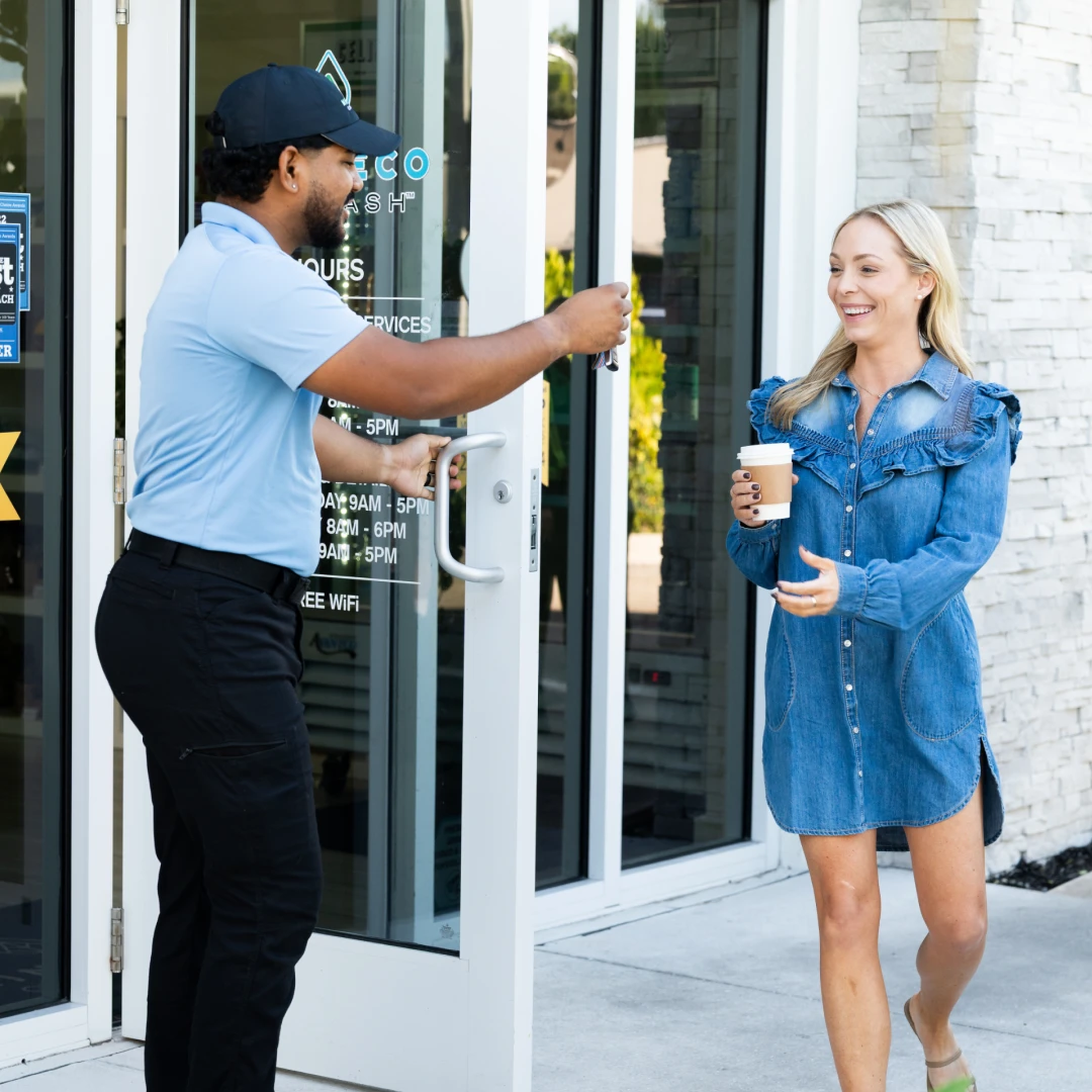 Mint Eco employee handing car keys to a customer
