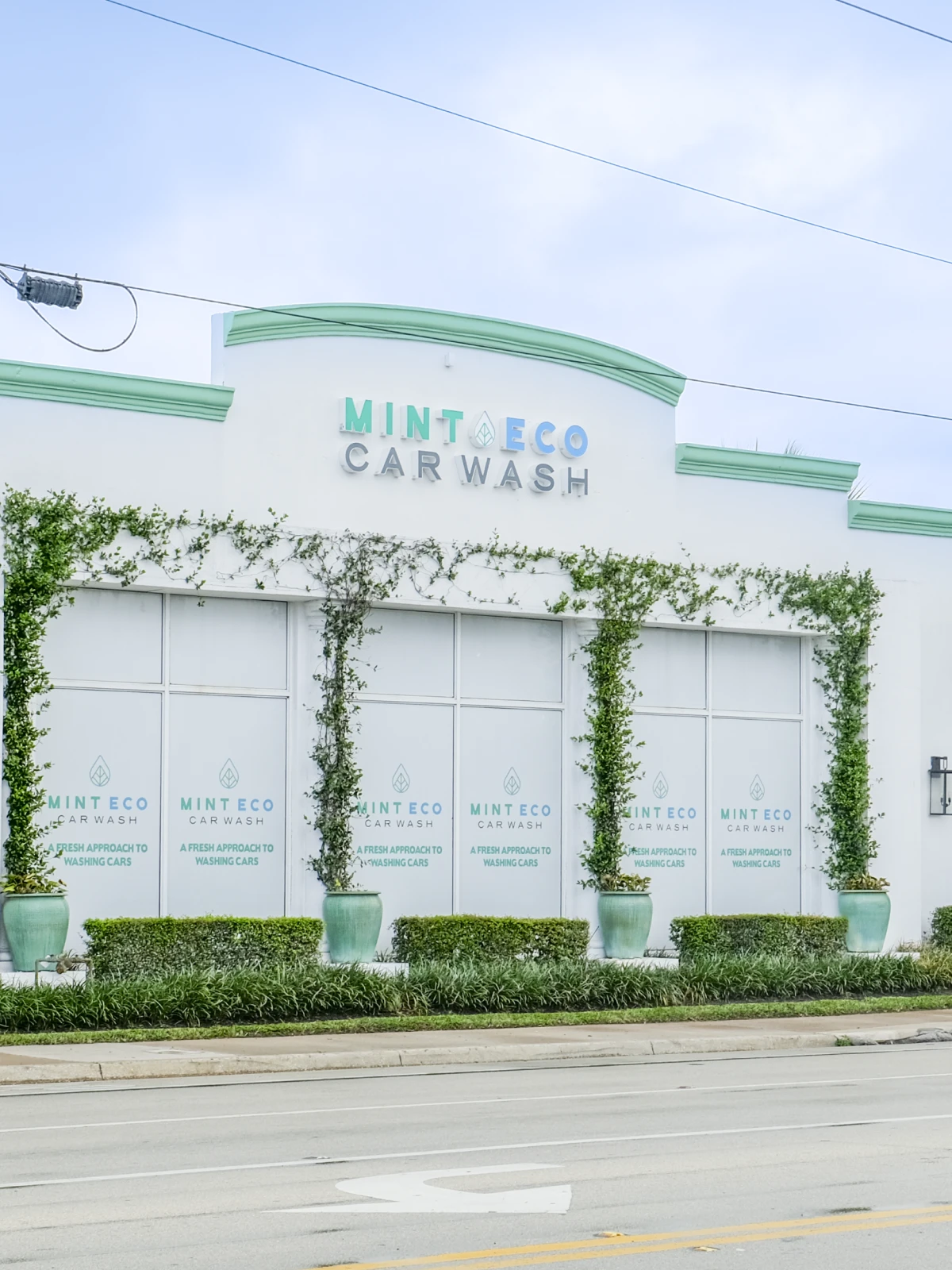 Exterior of the Mint Eco Car Wash building with signage at the Southern Blvd and Dixie Hwy location