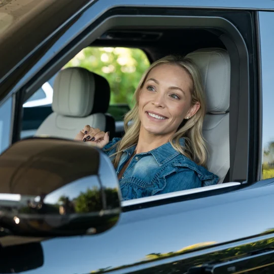 Woman smiling from inside a truck